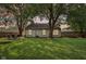 A well-maintained backyard with a patio, seating area, and mature trees, perfect for outdoor living and entertainment at 6760 Navigate Way, Indianapolis, IN 46250