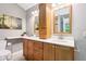 Bathroom featuring double sink vanity with wooden cabinets, drawers, and storage tower at 6760 Navigate Way, Indianapolis, IN 46250