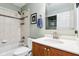 Bright bathroom features a shower and tub combination with a modern vanity and sink at 6760 Navigate Way, Indianapolis, IN 46250