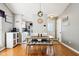 Comfortable dining area with modern lighting fixture and breakfast bar with convenient access to kitchen at 6760 Navigate Way, Indianapolis, IN 46250