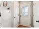 Bright foyer with hardwood floors, white doors, and a glass-paneled front door at 6760 Navigate Way, Indianapolis, IN 46250