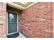 Close-up of a red brick entryway with a black front door and decorative brickwork at 6760 Navigate Way, Indianapolis, IN 46250