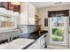 Stylish kitchen featuring sleek countertops, tile backsplash, and stainless steel fixtures with backyard view at 6760 Navigate Way, Indianapolis, IN 46250