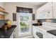 Modern kitchen features sleek countertops, white cabinetry, stainless steel appliances and view of the yard at 6760 Navigate Way, Indianapolis, IN 46250