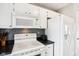 Well-lit kitchen with updated cabinets, appliances, stylish backsplash, and dark countertops at 6760 Navigate Way, Indianapolis, IN 46250