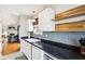 Well-equipped kitchen with sleek countertops, backsplash, and natural light is open to the living space at 6760 Navigate Way, Indianapolis, IN 46250