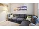 Inviting living room featuring a sectional sofa, soft carpet, and a floor lamp at 6760 Navigate Way, Indianapolis, IN 46250