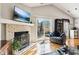 Relaxing living room featuring vaulted ceilings, brick fireplace, and sliding glass doors to outdoor patio at 6760 Navigate Way, Indianapolis, IN 46250