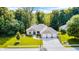 Beautiful home from above, showcasing its well-kept lawn, three-car garage, and tree-lined property at 6940 Mockernut Ct, Plainfield, IN 46168