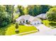 Aerial view of a home with a three-car garage, beautiful lawn, and mature trees at 6940 Mockernut Ct, Plainfield, IN 46168