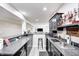 Basement wet bar featuring dark cabinetry, and countertop seating at 6940 Mockernut Ct, Plainfield, IN 46168