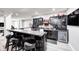Basement wet bar featuring sleek cabinetry, countertop seating and decorative sports memorabilia at 6940 Mockernut Ct, Plainfield, IN 46168