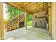 Covered patio with stairs leading to deck; outdoor storage and a cozy wicker chair are included at 6940 Mockernut Ct, Plainfield, IN 46168