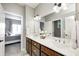 Bathroom with double sink vanity, large mirror, and view into bedroom at 6940 Mockernut Ct, Plainfield, IN 46168