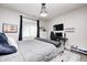 Comfortable bedroom featuring a large bed, wall-mounted TV and neutral color palette at 6940 Mockernut Ct, Plainfield, IN 46168
