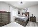 Cozy bedroom with neutral tones, a dark wooden bed frame, and natural light at 6940 Mockernut Ct, Plainfield, IN 46168