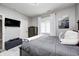 Comfortable bedroom featuring neutral walls, a gray bed, and modern furnishings at 6940 Mockernut Ct, Plainfield, IN 46168