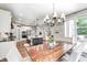 Open concept with a view into the dining area with a wood table and chair set, kitchen, and living room at 6940 Mockernut Ct, Plainfield, IN 46168