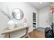 Elegant entryway with a console table, round mirror, and decorative vase at 6940 Mockernut Ct, Plainfield, IN 46168