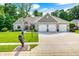 Traditional home with three-car garage, well-manicured lawn, and tasteful landscaping at 6940 Mockernut Ct, Plainfield, IN 46168