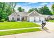 Well-manicured lawn, landscaping, and attractive exterior of a home with a three-car garage at 6940 Mockernut Ct, Plainfield, IN 46168