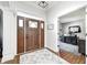 Foyer features a dark wood door with sidelights and transom window, leading to an office space at 6940 Mockernut Ct, Plainfield, IN 46168