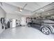 A spacious garage with epoxy floors, storage, and a black SUV at 6940 Mockernut Ct, Plainfield, IN 46168