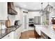Spacious kitchen featuring granite countertops, stainless steel appliances, and a stylish range hood at 6940 Mockernut Ct, Plainfield, IN 46168