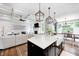 Open-concept kitchen with granite countertops, farmhouse sink, and a view to the living and dining area at 6940 Mockernut Ct, Plainfield, IN 46168