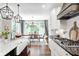 Bright kitchen showcasing granite countertops, a farmhouse sink, stainless appliances, and an adjacent dining space at 6940 Mockernut Ct, Plainfield, IN 46168