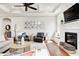 Comfortable living room with fireplace, built-in benches, hardwood floors, and Gathering photos at 6940 Mockernut Ct, Plainfield, IN 46168