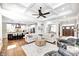 Spacious open-concept living area with fireplace, hardwood floors, and view of the kitchen at 6940 Mockernut Ct, Plainfield, IN 46168
