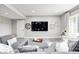 Inviting living area featuring comfortable seating, a large TV, and stylish decor at 6940 Mockernut Ct, Plainfield, IN 46168