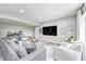 Cozy living room with a large gray sectional, a large tv, and light gray walls at 6940 Mockernut Ct, Plainfield, IN 46168