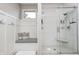 This bathroom features a white subway tile shower and a built in bench with storage hooks and seat cushions at 6940 Mockernut Ct, Plainfield, IN 46168
