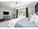 The main bedroom features a tray ceiling, a TV, and large windows overlooking the back yard at 6940 Mockernut Ct, Plainfield, IN 46168