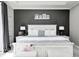 The main bedroom features a dark accent wall and a beautifully decorated farmhouse-style bed frame at 6940 Mockernut Ct, Plainfield, IN 46168