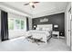 Main bedroom featuring a trey ceiling, large window, and neutral color tones at 6940 Mockernut Ct, Plainfield, IN 46168