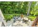 Aerial view of an outdoor patio featuring a fire pit, seating, and mature trees at 6940 Mockernut Ct, Plainfield, IN 46168