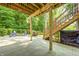Covered patio with a fire pit, seating area, and lush backyard at 6940 Mockernut Ct, Plainfield, IN 46168