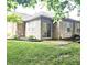 Brick home featuring a sliding glass door leading to a green backyard with brick pavers at 6956 Park Square Dr # D, Avon, IN 46123