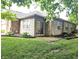 Brick home featuring a sliding glass door and a well-maintained backyard with green grass at 6956 Park Square Dr # D, Avon, IN 46123