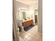Bright bathroom with a large mirror, warm vanity, a toilet, and doorway to the bedroom at 6956 Park Square Dr # D, Avon, IN 46123