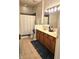 Bathroom with a large mirror, wooden vanity, shower with white curtain and tan tile flooring at 6956 Park Square Dr # D, Avon, IN 46123