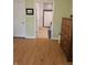 Bedroom featuring hard wood floor, dresser, and an open door to the bathroom at 6956 Park Square Dr # D, Avon, IN 46123