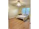 Cozy bedroom with hardwood floors, a ceiling fan, a large window and a comfortable bed at 6956 Park Square Dr # D, Avon, IN 46123