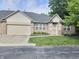 Attractive brick home showcasing a manicured lawn, garage, and inviting front entrance at 6956 Park Square Dr # D, Avon, IN 46123