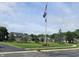 A beautiful common ground featuring well-maintained lawns, mature trees, and a central flagpole display at 6956 Park Square Dr # D, Avon, IN 46123