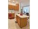 Kitchen featuring wood cabinets, white appliances, tile flooring, and a breakfast bar at 6956 Park Square Dr # D, Avon, IN 46123