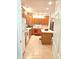 Kitchen featuring wood cabinets, white appliances, tile flooring, and a breakfast bar at 6956 Park Square Dr # D, Avon, IN 46123